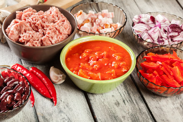Ingredients ready for preparing chili con carne. Mincemeat, papr