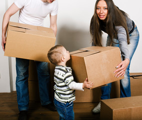 stock-photo-smiling -family-in-new-hous e-playing-with-boxe s