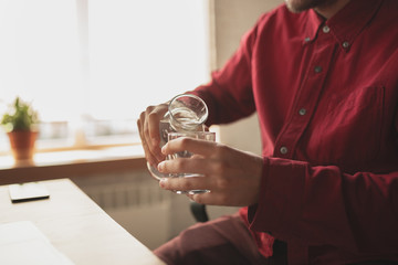 Crazy games. Caucasian entrepreneur, businessman, manager trying to work in office. Looks funny, lazy, spending time. Concept of work, finance, business, success and leadership. Deadline, hurry up