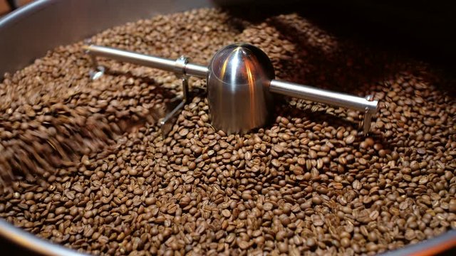 Closeup Selective focus coffee roaster with coffee beans.