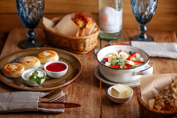 set table with beautiful healthy breakfast cheese pancakes porridge with fruits coffee bread side view horizontal