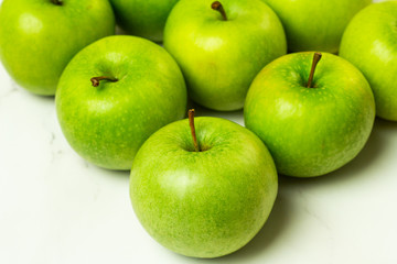 fresh green apples on a white background close-up

