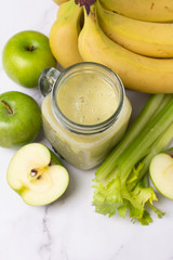 celery and fresh fruit smoothie and ingredients top view close-up
