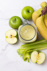 celery and fresh fruit smoothie and ingredients top view
