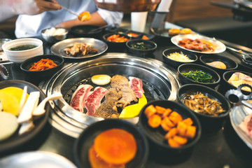 Korea bbq style restaurant  with meat and vegetable side diesh.