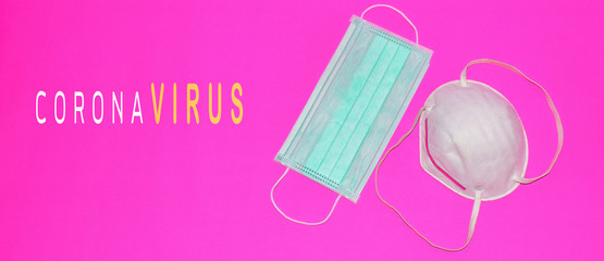 Two masks to protect against dust and viruses on a pink background with the message coronavirus COVID-19.