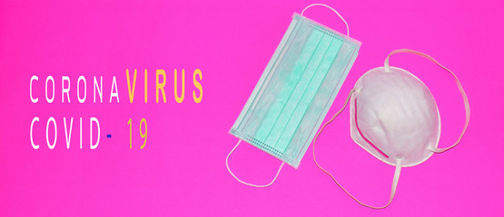 Two masks to protect against dust and viruses on a pink background with the message coronavirus COVID-19.