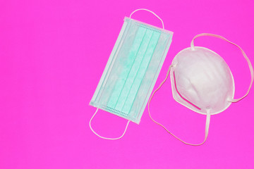 Two masks for dust and virus protection on a pink background