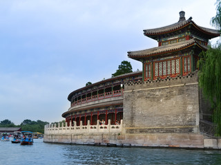 China. Beijing. Walk on katkmaran. Chinese travel. Big Beijing park. Bei Hai. Chinese relax. Chinese enjoy. A nice place. Big lake. Lots of lotuses. Old building. Chinese pagoda. Good weather.