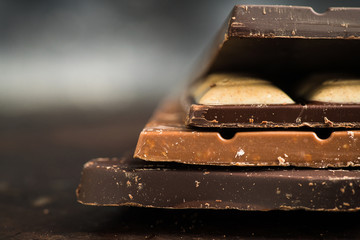 Chocolate bar on the rustic background. Selective focus. Shallow depth of field.