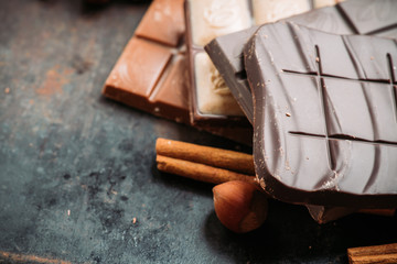 Chocolate bar on the rustic background. Selective focus. Shallow depth of field.