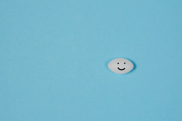 Different pills on a blue background. health and medicine. smile