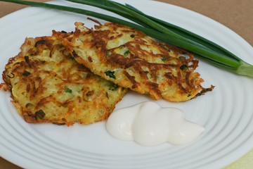 Dish of Russian Siberian cuisine: potato pancakes with green onions. Homemade food cooked with love.
