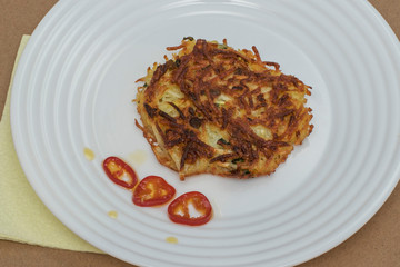 Dish of Russian Siberian cuisine: potato pancakes with green onions. Homemade food cooked with love.
