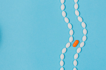 Different pills on a blue background. health and medicine. intestines