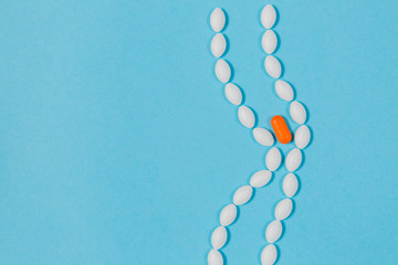 Different pills on a blue background. health and medicine. intestines