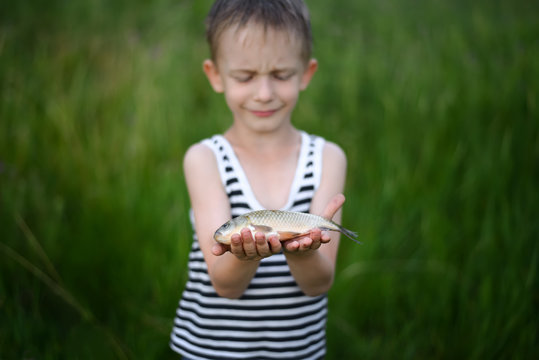 boy is feeling pity of fish