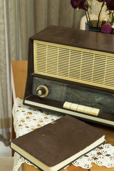 The old vintage radio on the wooden table.