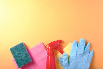 Accessories for cleaning, rags, sponges, spray on an orange background