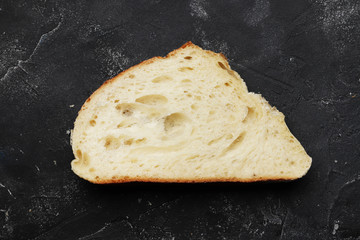 Sliced fresh white bread on a dark table