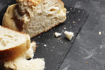 Sliced fresh white bread on a dark table