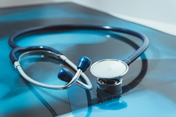 Stethoscope on chest x-ray film. Diagnosing pneumonia caused by Covid-19