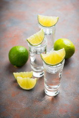 Tequila shots on the dark rustic background. Selective focus. Shallow depth of field.
