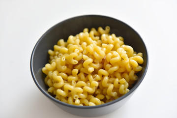 boiled macaroni with meat on a plate on a white background