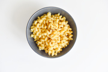 boiled macaroni with meat on a plate on a white background