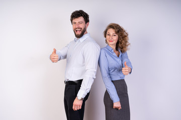 A man and a woman in business style clothing, white background, show the class the hands