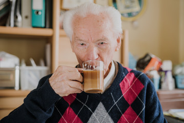 Portrait of happy senior drinking coffee