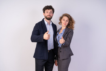A man and a woman in business style clothing, white background, show the class the hands