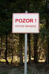 Fototapeta premium Border crossing on borderline and frontier of Czech Republic / Czechia. Signboard and placard with text (translation from Czech language: Warning. State border).