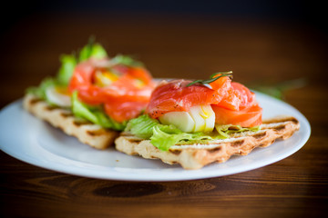 fried bread toast with salad leaves and salted red fish