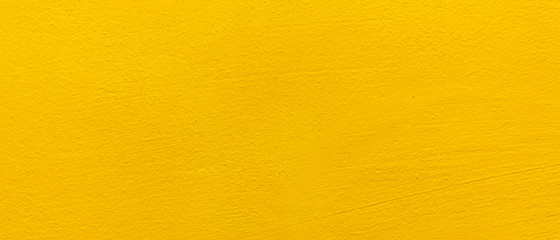 Blurred Yellow stucco wall background. Yellow painted cement wall texture.