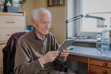 Positive Senior using Digital Tablet