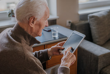 Positive Senior using Digital Tablet