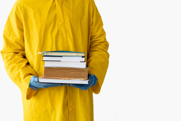 Close-up of student's hands dressed in medical gloves. A lot of textbooks, books and notebooks....