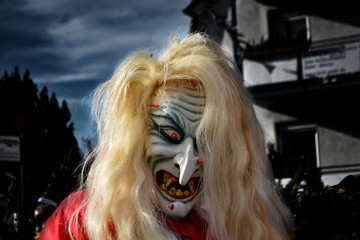 A man on halloween night with the mask of a devil