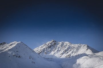 Fototapeta na wymiar Mountain peak in the snow