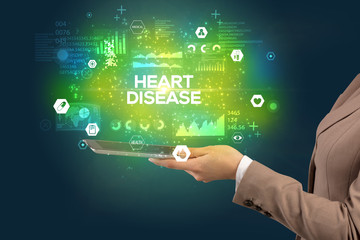 Close-up of a touchscreen with HEART DISEASE inscription, medical concept