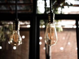 Decorative antique edison style light bulbs in the cafe. Lighting decor indoors concept.