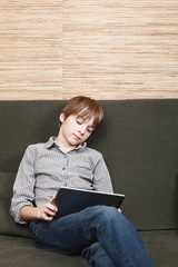 Frustrated boy with tablet confined at home during isolation