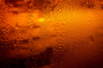 Fototapeta na wymiar PhotosSearch by imageClose up view of the ice cubes in dark cola background. Texture of cooling sweet summer's drink with foam and macro bubbles on the glass wall. Fizzing or floating up to top o