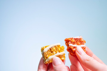 Two halves of a useful batnik in a woman's hands on a light background. Healthy eating in the office