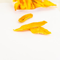 Fototapeta na wymiar Dried Mango slice on white clear background. Orange fruit. Healthy snack. Mock-up. Copy space.
