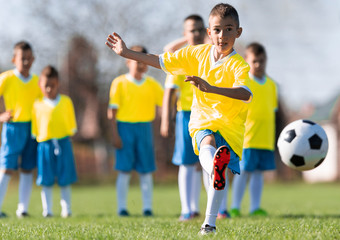 Obraz na płótnie Canvas Boys play soccer sports field
