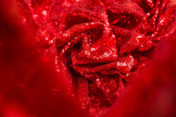 red shiny sequined pleated sequin fabric as background and texture