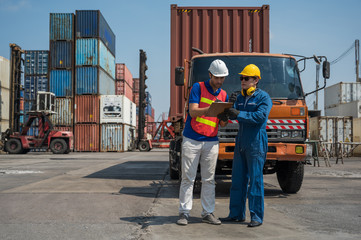 Fototapeta na wymiar Foreman and dock worker staff working checking at Container cargo harbor holding clipboard. Business Logistics import export shipping concept.