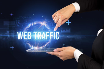 Close-up of a touchscreen with WEB TRAFFIC inscription, new technology concept